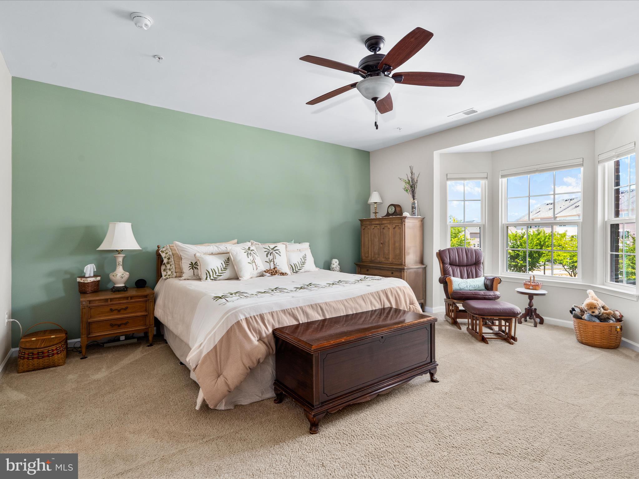 5039 Small Gains Way Frederick, MD 21703 - Photo 5 of 34 a spacious bedroom with a bed a couch and a chandelier