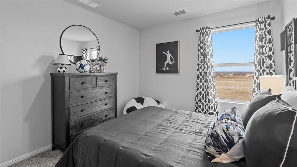 176 Mojave Road Boyd, TX 76023 - Photo 26 of 40 a bedroom with a bed and a chandelier