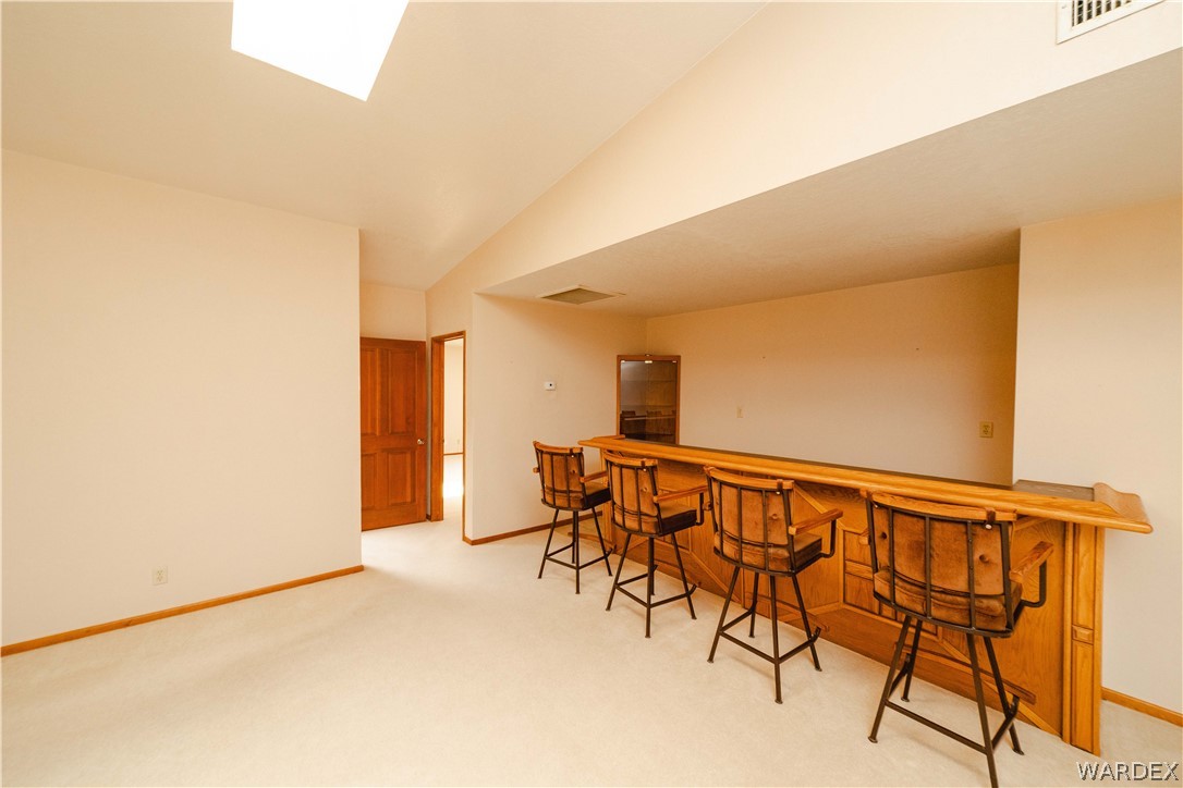 2100 East Valley View Road Kingman, AZ 86409 - Photo 9 of 53 Recessed built-in bar with seating for four, featuring a wood finish