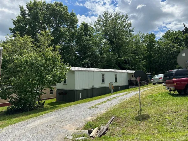 a white house that has a tree in front of it