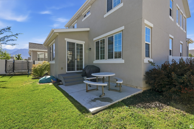 3244 West 1670th Street North Provo, UT 84601 - Photo 51 of 56 Rear exterior featuring a concrete patio, sliding glass door access, and a multi-pane window configuration