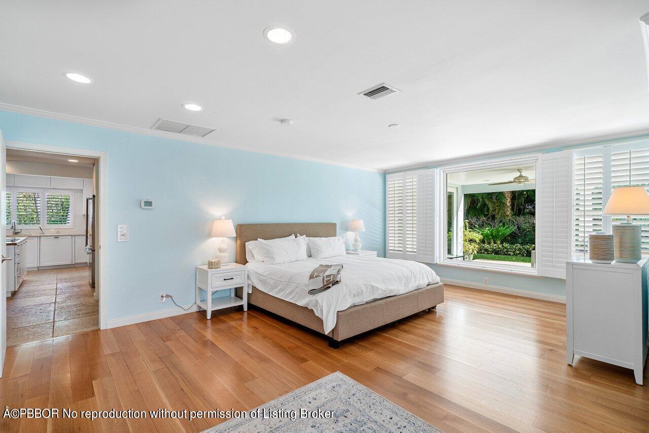 256 Mockingbird Trail Palm Beach, FL 33480 - Photo 14 of 25 a bedroom with a large bed and a large window