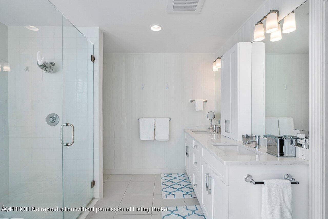 256 Mockingbird Trail Palm Beach, FL 33480 - Photo 16 of 25 a bathroom with a double vanity sink mirror and shower
