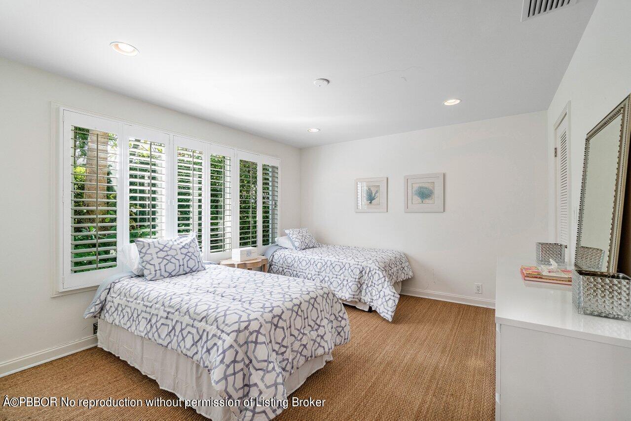 256 Mockingbird Trail Palm Beach, FL 33480 - Photo 17 of 25 a bedroom with two beds and a flat screen tv