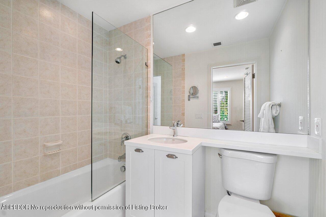 256 Mockingbird Trail Palm Beach, FL 33480 - Photo 18 of 25 a bathroom with a sink toilet and shower
