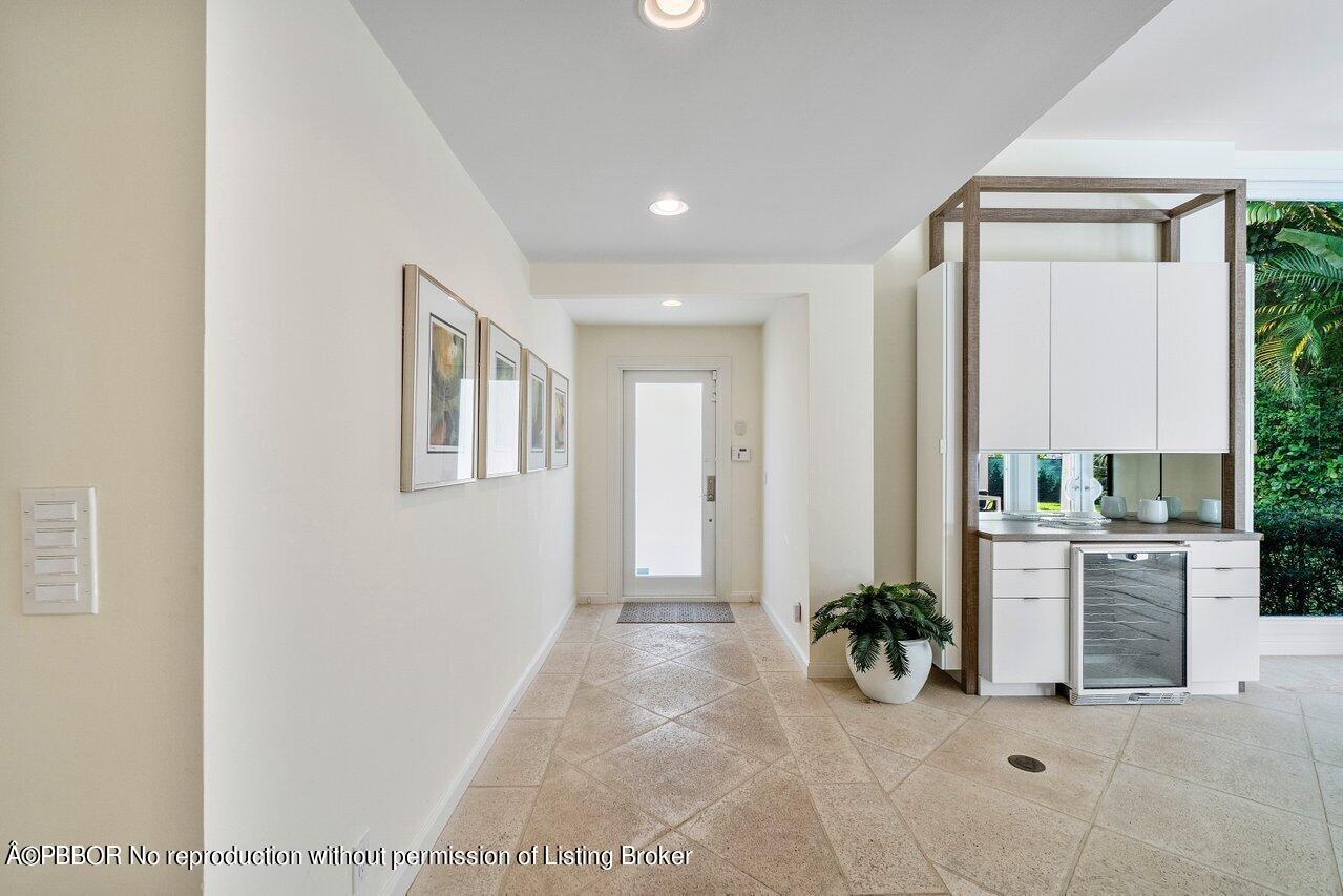 256 Mockingbird Trail Palm Beach, FL 33480 - Photo 4 of 25 a view of a hallway with workspace and living room