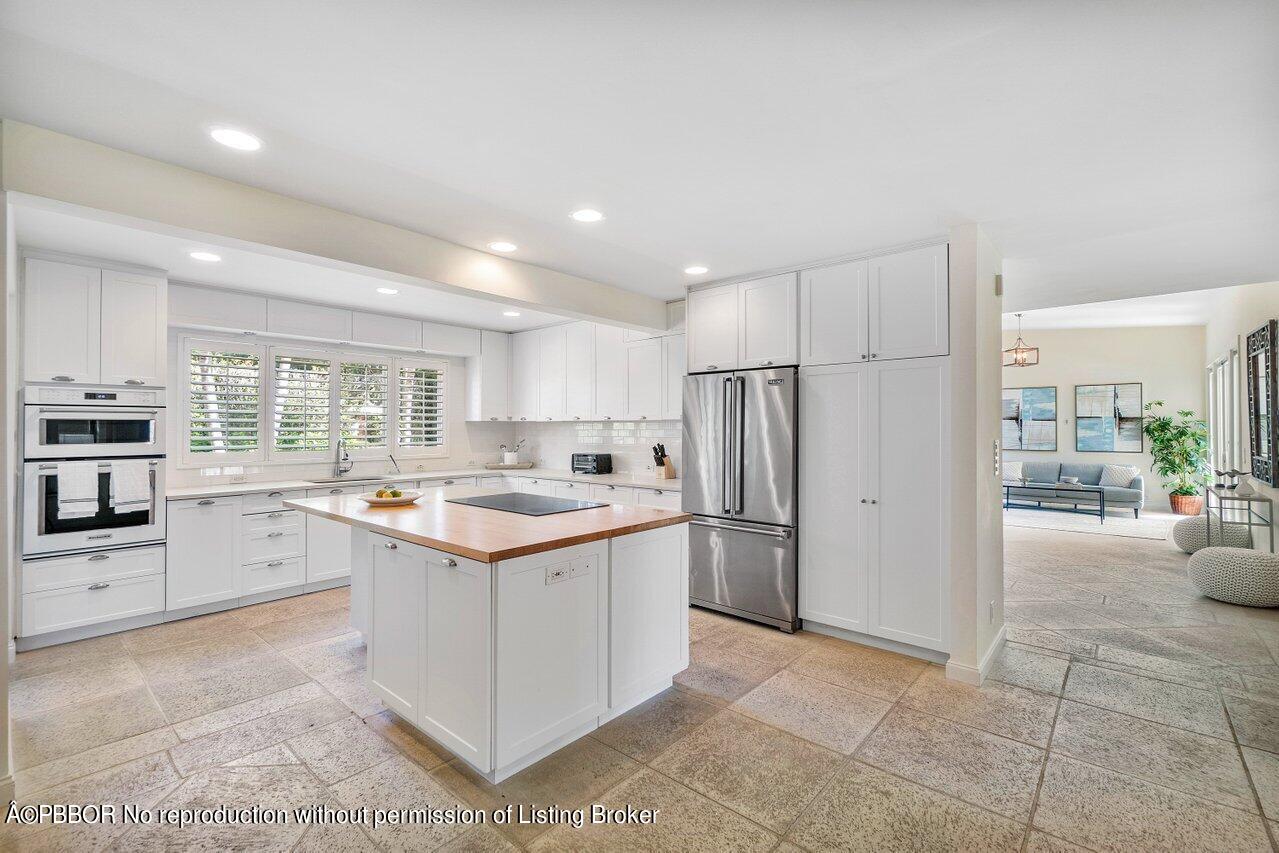 256 Mockingbird Trail Palm Beach, FL 33480 - Photo 7 of 25 a kitchen with a stove a refrigerator and a cabinets