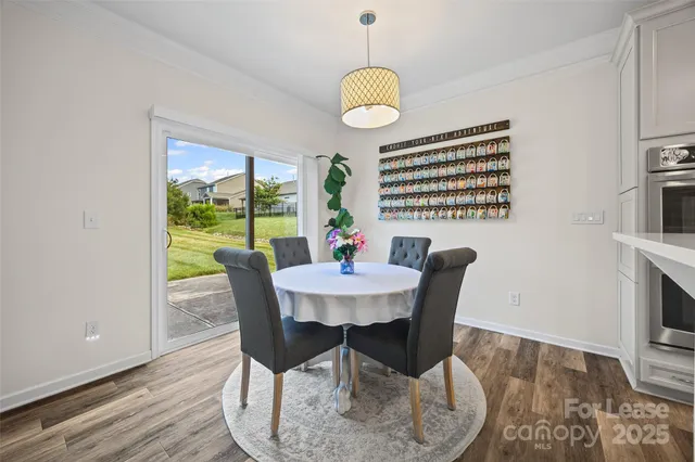 a dining room with furniture a rug and wooden floor