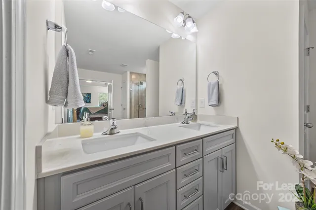 a bathroom with a double vanity sink mirror and vanity