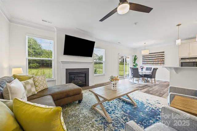 a living room with furniture fireplace and a flat screen tv