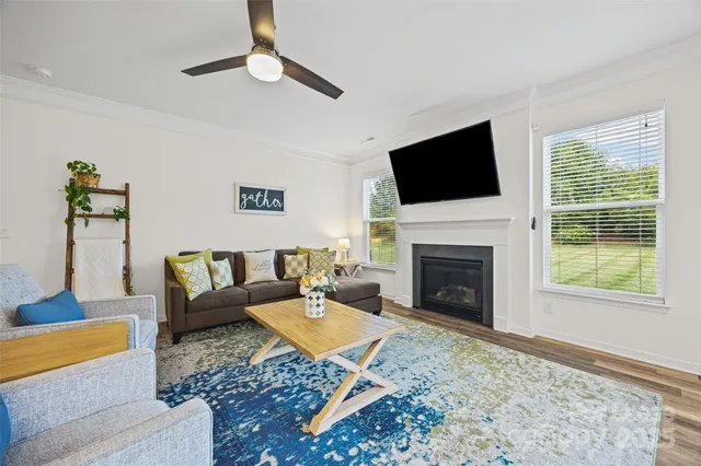 a living room with furniture a rug and a fireplace