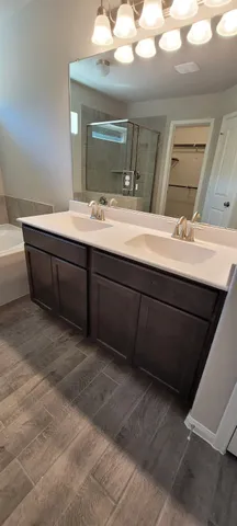 a bathroom with a double vanity sink and a mirror