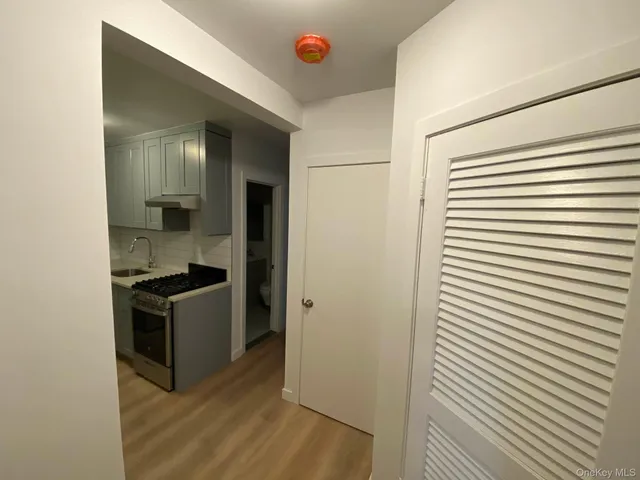 a kitchen with stainless steel appliances granite countertop a sink and a refrigerator