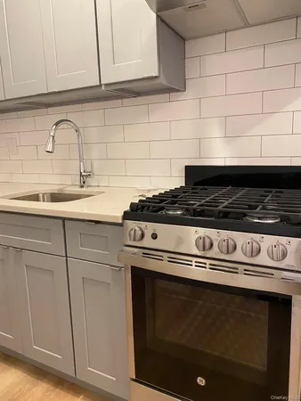 a stove top oven sitting inside of a kitchen