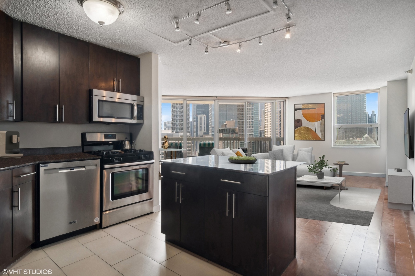 545 North Dearborn Street, Unit 2610 Chicago, IL 60654 - Photo 4 of 37 a kitchen with stainless steel appliances granite countertop a stove top oven a sink dishwasher a dining table and chairs with wooden floor