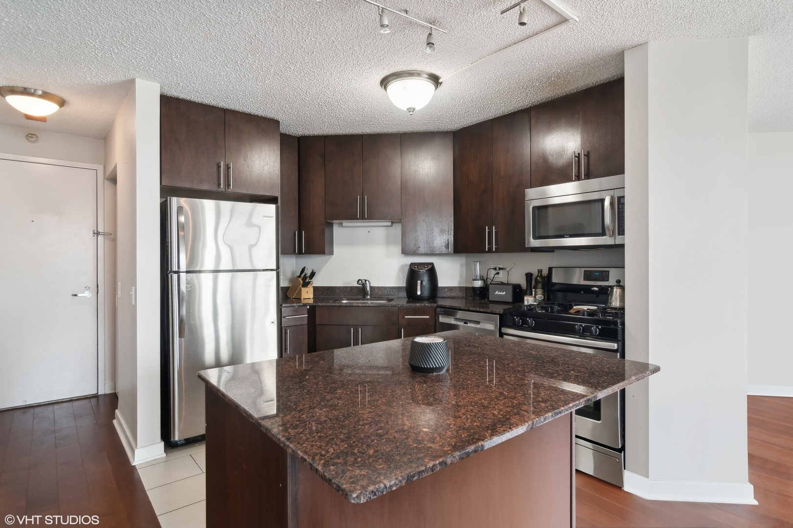 545 North Dearborn Street, Unit 2610 Chicago, IL 60654 - Photo 8 of 37 a kitchen with stainless steel appliances granite countertop a sink a stove and refrigerator