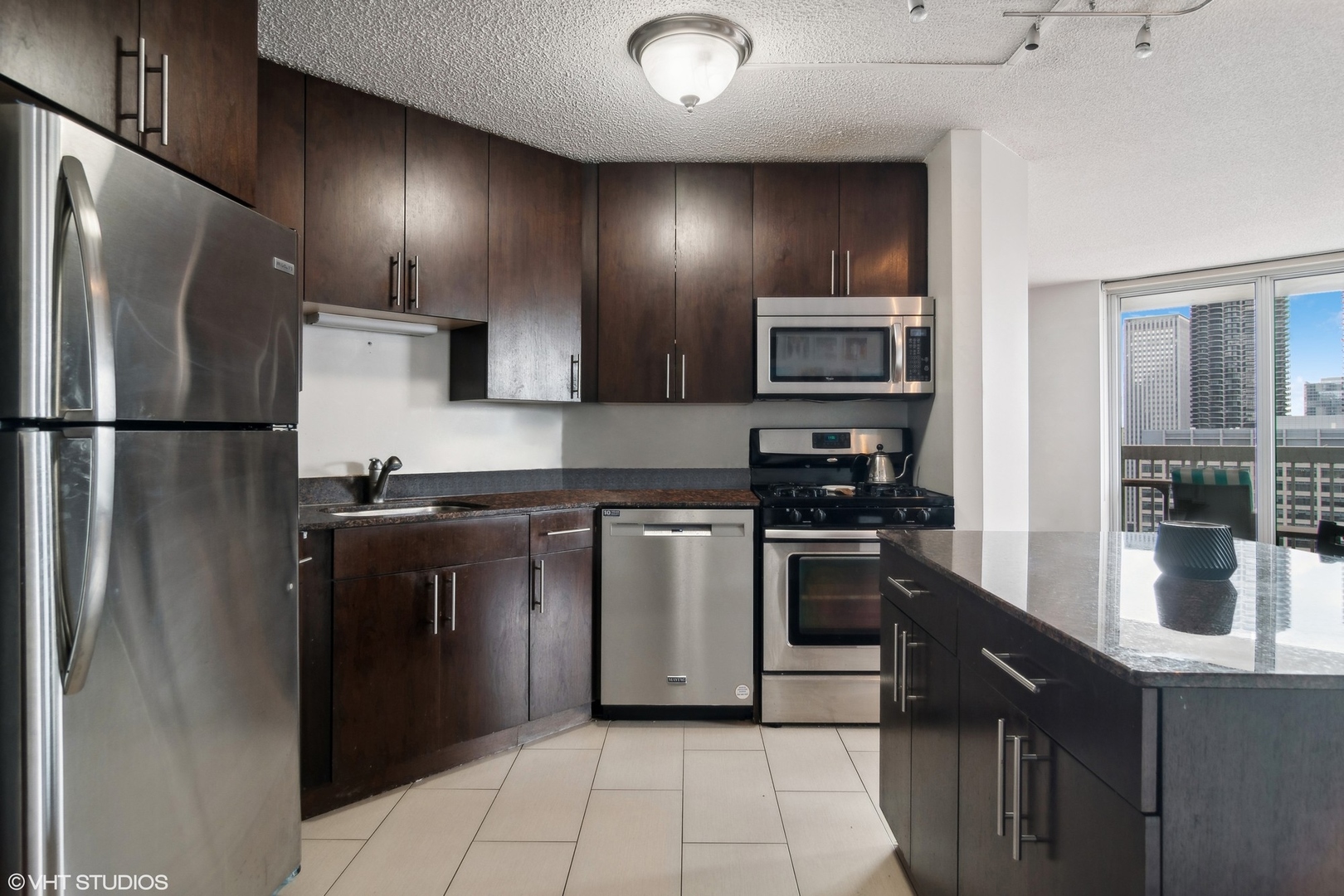 545 North Dearborn Street, Unit 2610 Chicago, IL 60654 - Photo 9 of 37 a kitchen with stainless steel appliances granite countertop a refrigerator a stove and a sink