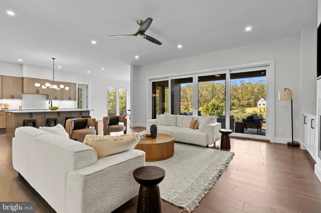 a bathroom with a double vanity sink a large mirror a bathtub and window