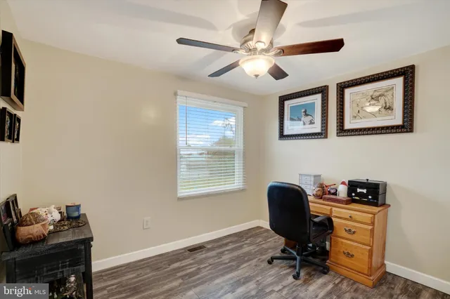 a view of workspace with wooden floor windows cabinet