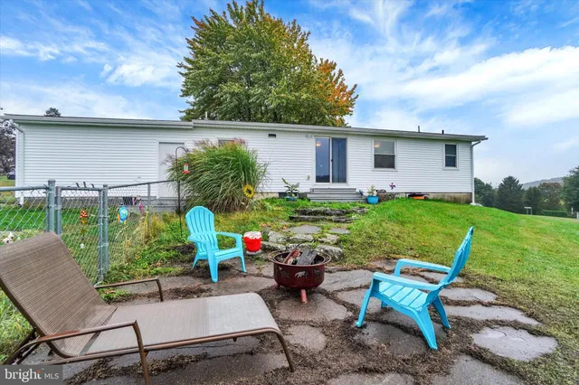 a view of backyard with seating space and trees