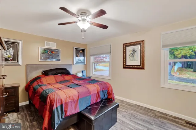 a bedroom with a bed and a painting on the wall