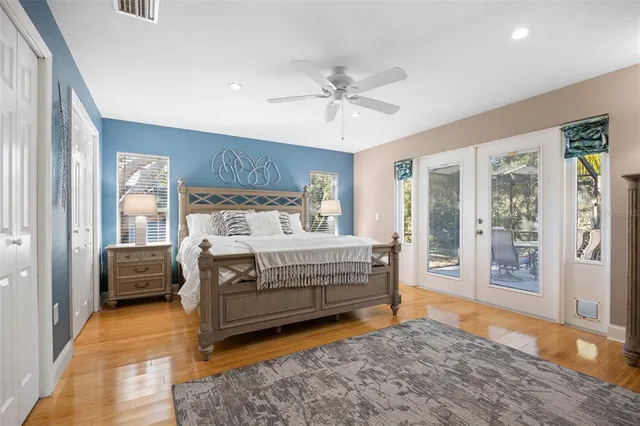 a bedroom with a bed and large window