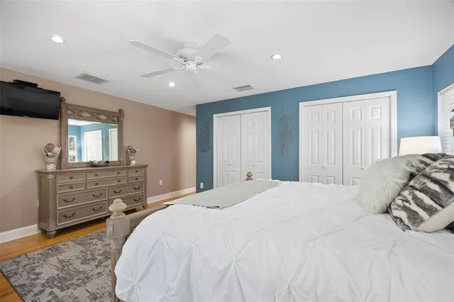 a spacious bedroom with a large bed and a dresser