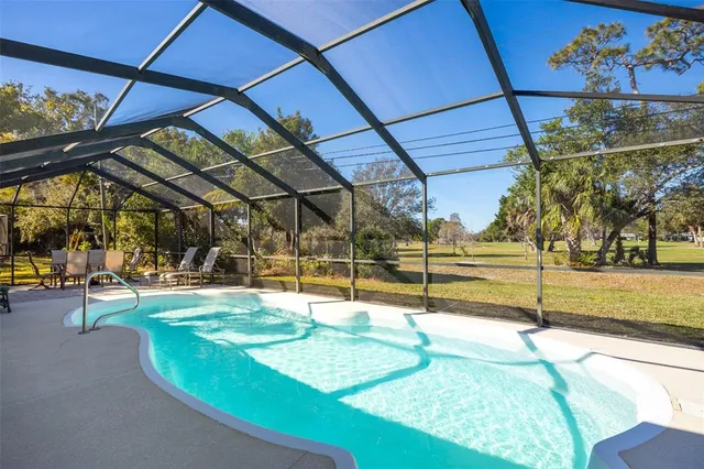 a view of a swimming pool with a bench in patio