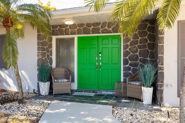 a view of a house with a door and a potted plant