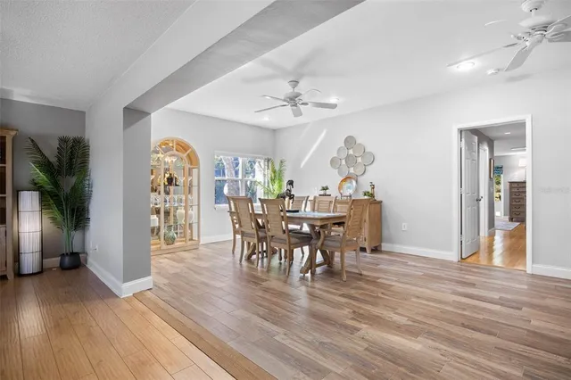 a view of a dining room with furniture and wooden floor