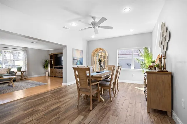 a view of a dining room with furniture and wooden floor