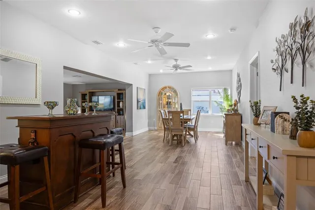 a view of a a dining room with furniture window and wooden floor