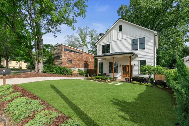 a front view of a house with a yard and porch