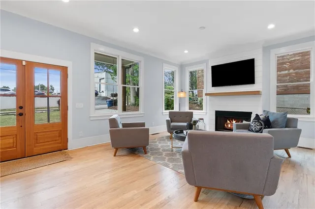 a living room with furniture kitchen and a large window