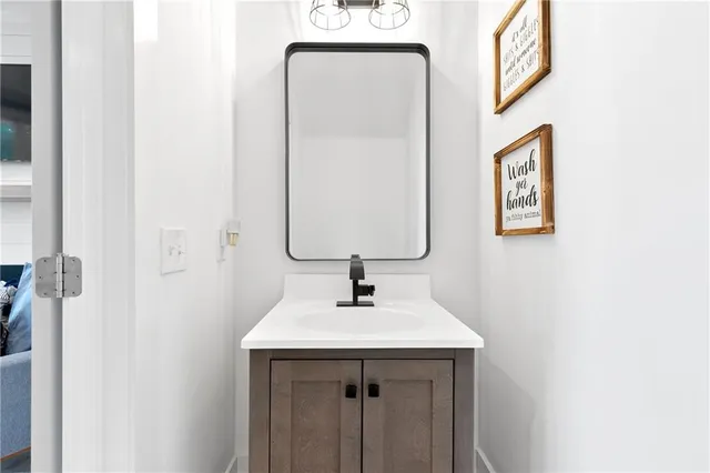 a living room with furniture a flat screen tv and a large window