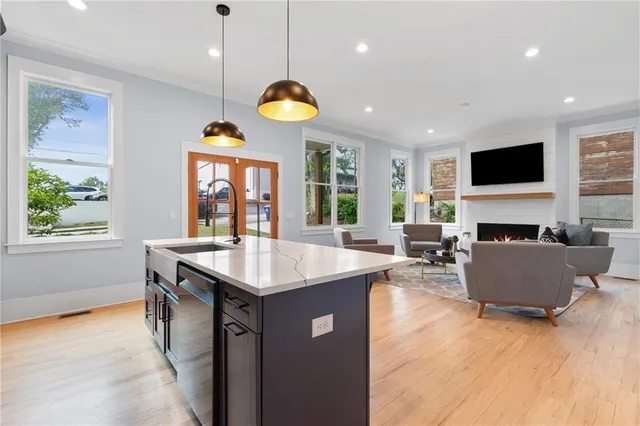 a kitchen with stainless steel appliances granite countertop a stove a sink and a microwave