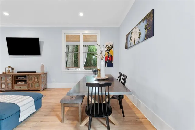 a living room with furniture a flat screen tv and a window