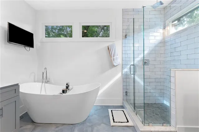 a bathroom with a bathtub sink and mirror