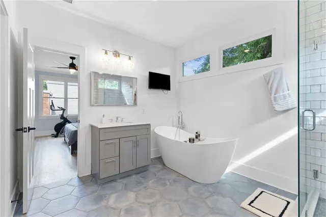 a bathroom with a shower sink and mirror