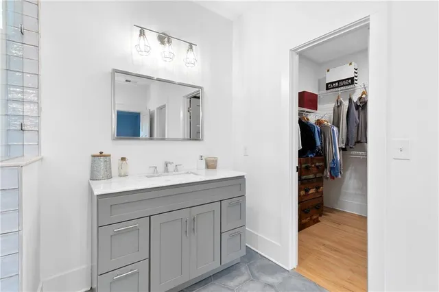 a view of walk in closet with clothes and shoes