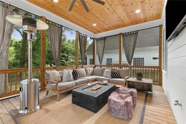 a living room with furniture and a floor to ceiling window