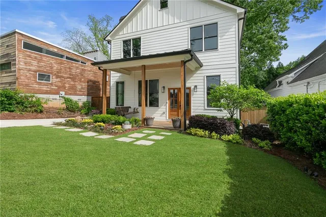 a front view of a house with a yard and porch