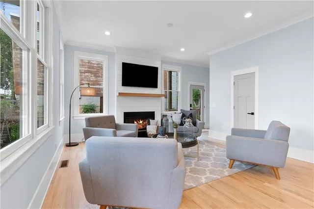 a living room with furniture fireplace and flat screen tv