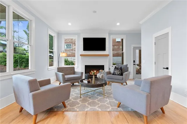 a living room with furniture a flat screen tv and a fireplace