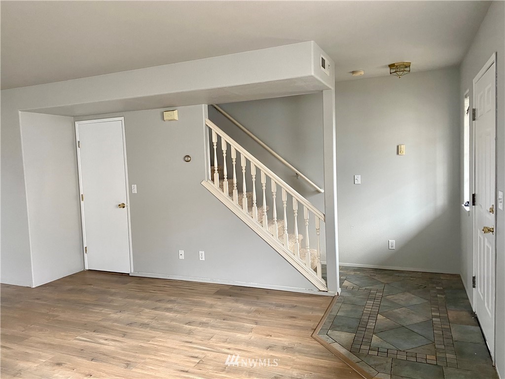 3966 Broadmoor Loop Bremerton, WA 98310 - Photo 2 of 32 a view of a hallway with wooden floor and staircase