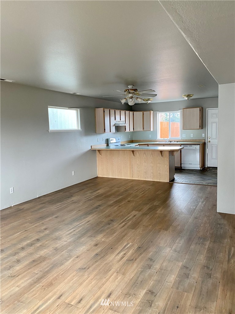 3966 Broadmoor Loop Bremerton, WA 98310 - Photo 13 of 32 a kitchen with a wooden floor and a window