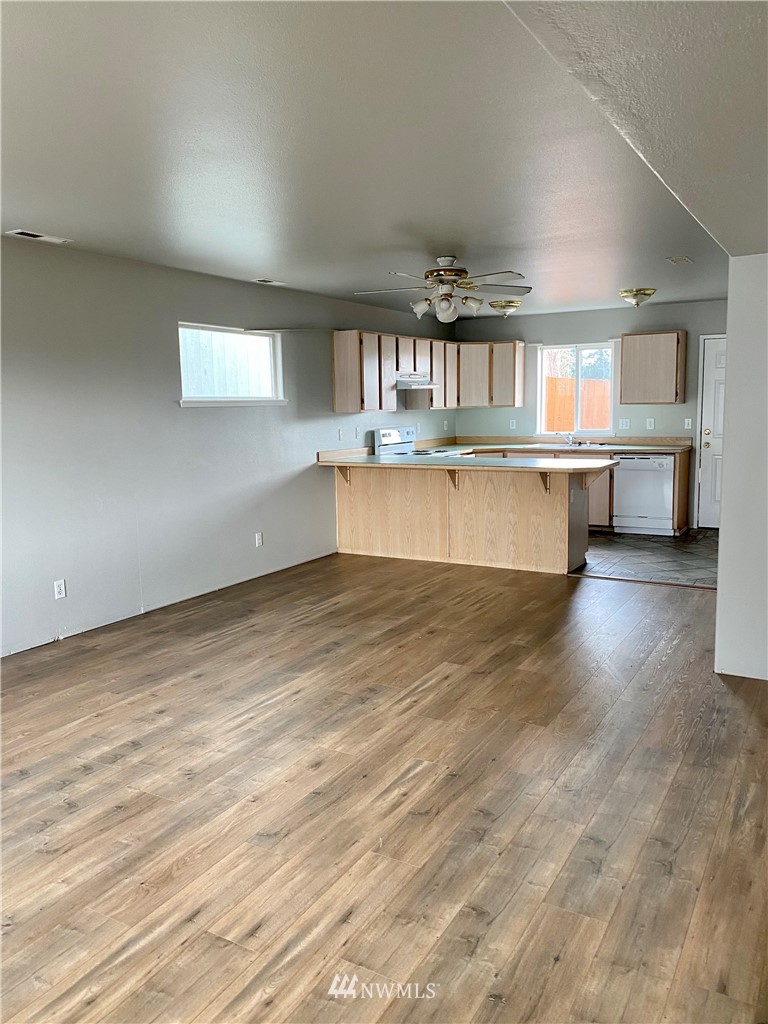 3966 Broadmoor Loop Bremerton, WA 98310 - Photo 4 of 32 an empty room with wooden floor and windows