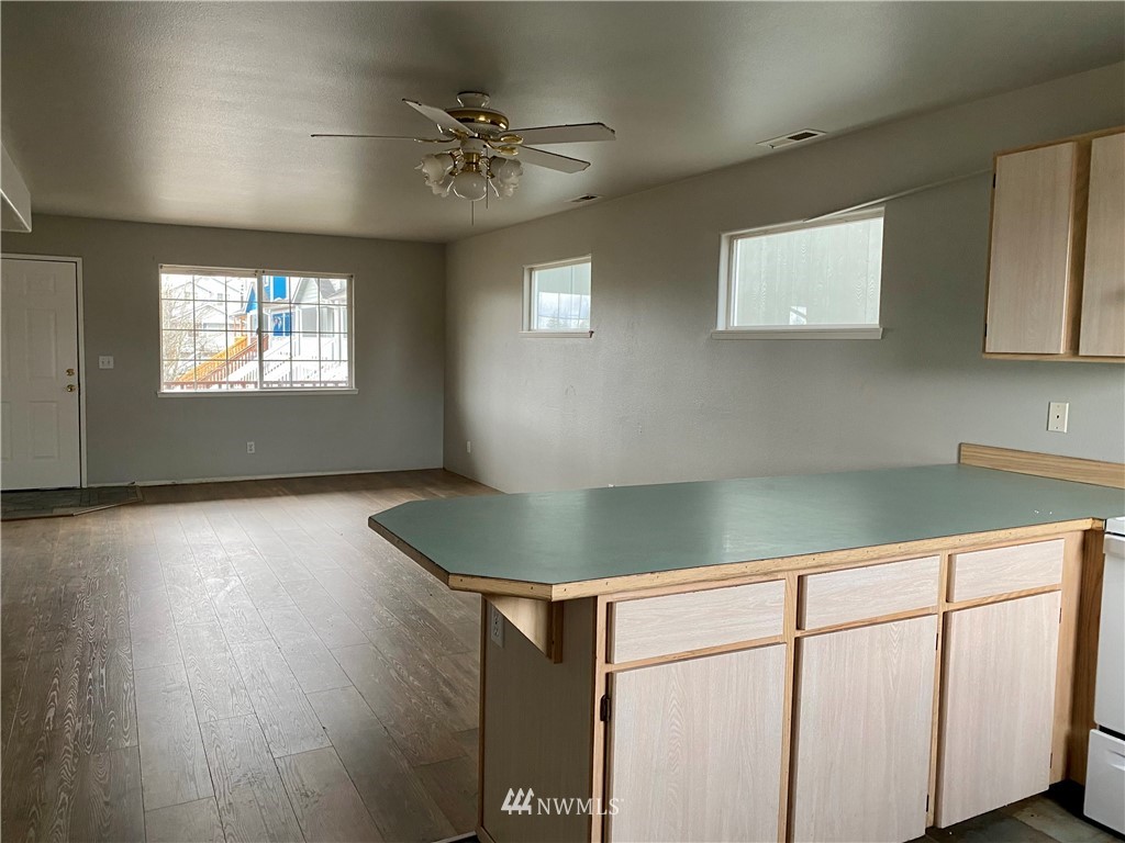3966 Broadmoor Loop Bremerton, WA 98310 - Photo 7 of 32 a kitchen with kitchen island a counter top space and a sink