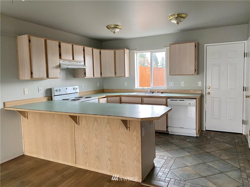3966 Broadmoor Loop Bremerton, WA 98310 - Photo 9 of 32 a kitchen with a sink cabinets and window