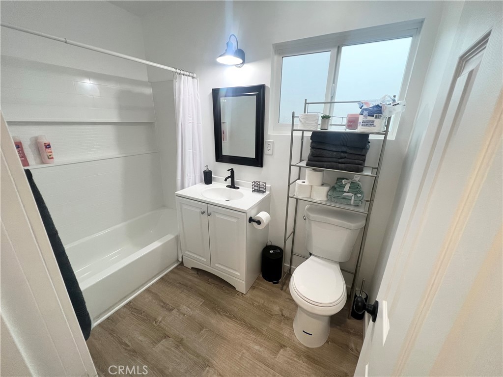 a bathroom with a toilet sink a mirror and vanity